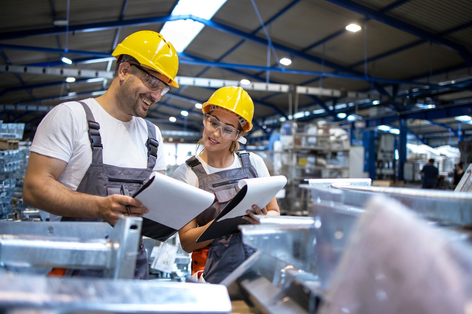 Two colleagues going over documentation in a production hall